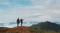 The man and woman standing on a mountain with a beautiful landscape 4k or 4k+ Resolution