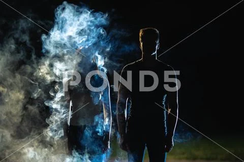 The man and woman standing in the smoke Stock Photos