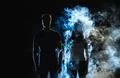 The man and woman standing in the smoke Photo