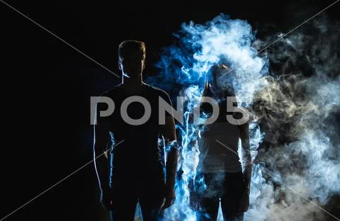 The man and woman standing in the smoke Stock Photos