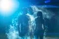 The man and woman standing in the smoke on a bright light background Photo