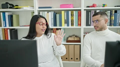 Man and woman students using computer stretching arms at university classroom 스톡 동영상 237281619