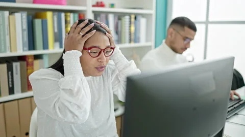 Man and woman students using computer stressed at university classroom 스톡 동영상 237281648