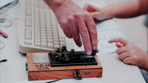 A man and a woman using a telegraph device with a decipher Stock Footage 289920819