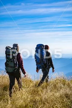 The man and a woman walking on the mountain with a beautiful view Stock Photos
