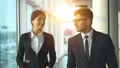 The man and a woman walking near panoramic windows. slow motion 4k or 4k+ Resolution