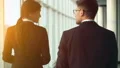 The man and a woman walking near the window in the office center. slow motion HD Footage