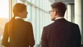 The man and a woman walking near the window in the office center. slow motion 4k or 4k+ Resolution