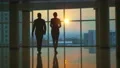 The man and woman walking in the office hall on a sunset background. slow motion 4k or 4k+ Resolution