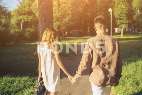 Man and woman walking in the park Stock Photos