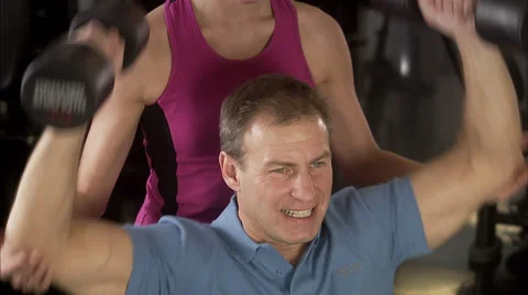 A man and a woman weight training at a Stock Video Pond5