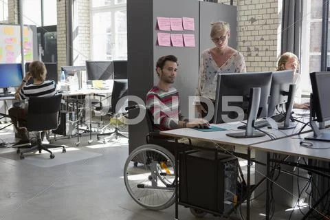 Man and woman working on computer in office Stock Photos
