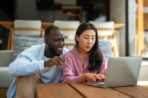 Man and woman working remotely using laptop. Male female freelancers working Stock Photos
