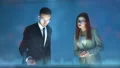 The man and a woman working with a virtual screen on the hologram background 4k or 4k+ Resolution