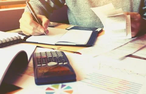 Man and writing make note and calculate about cost . Stock Photos