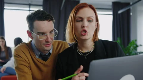 Man and a young woman during brainstorming in an open space in the office Stock Footage 257422553