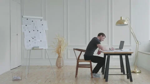 A man in anger sweeps documents from the table. Stock Footage 131273854