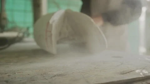Man angle grinding stone and causing dust Stock Footage 274996298
