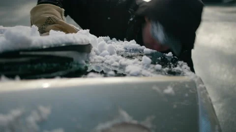 A Man Angrily Scrapes and Cleans Snow and Hits His Face 스톡 동영상 231172018