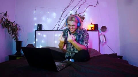 Man is angry with someone they see online and shows them obscene gestures while Stock Footage 277431132