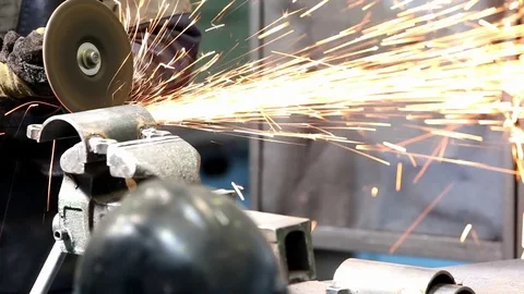 Man with Angular grinding machine grinds the metal part Stock Footage 76856885