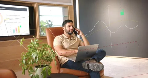 Man answering cell call discussing sales animated trend lines sweeping beside Stock Footage 334307924