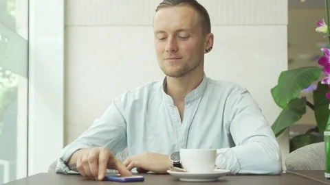 Man answering message and drinking coffee Stock Footage 79090696