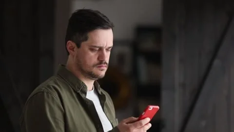 Man answers an unknown phone call at home Stock Footage 150355101