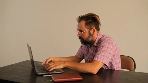 Man anxiously working on a laptop Video stock 245224830