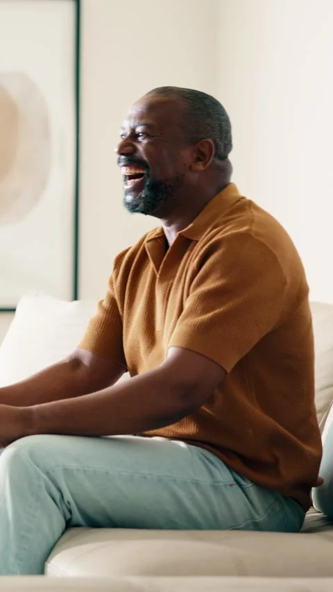 Man, applause and watching tv on sofa with sports game, goal celebration and Stock Footage 338009889