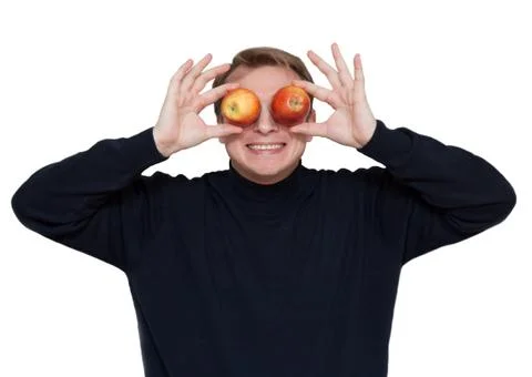Man with apple on eye Stock Photos