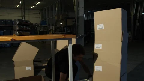 Man applies barcodes on boxes in coffee roasting workshop Stock Footage 266292864