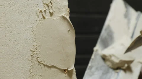 Man applies putty to wall edges ensuring well-defined structure Stock-Footage 304423751