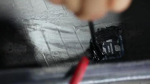 Man applies tar to Universal Patch on internal surface of tyre during car wheel 스톡 동영상 276366523