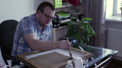 Man apply primer on canvas Stock Footage 62729356
