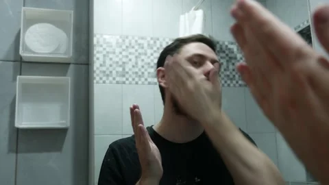 Man applying beard cream and combing beard for styling, close-up   Stock Footage 331241726