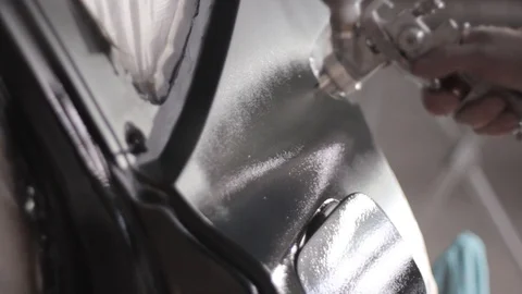 Man applying black primer to a car with a spraying gun Stock-Footage 129023262