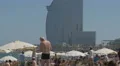 Man applying bronzing lotion on the beach in Barcelona 4k or 4k+ Resolution