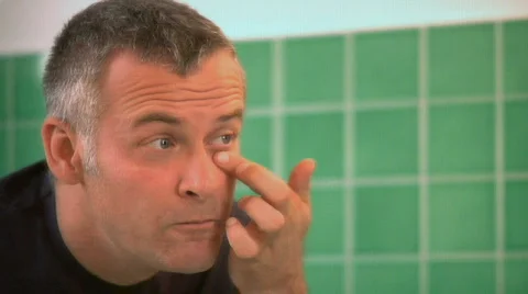 Man applying eye cream Stock Footage 862599