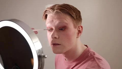 Man Applying Eyeshadow Makeup Routine in Front of Mirror Stock Footage 309977453