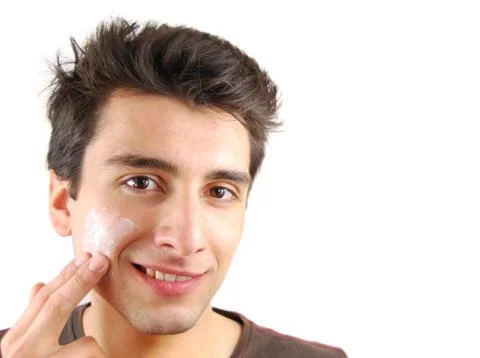 Man applying face cream Stock Photos