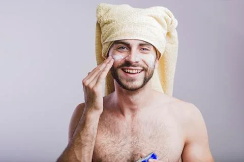 Man applying face cream Stock Photos