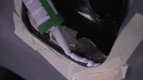 Man applying hermetic liquid during car body repair Stock-Footage 130576602