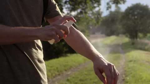 Man is applying insect repellent . Stock Footage 278910415