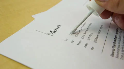 Man applying liquid paper to cover up To: line in memo Stock Footage 32243102