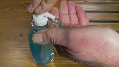 A man applying liquid soap to his hands, then rubbing it in. Stock Footage 145261450