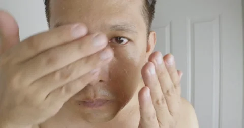 Man applying moisturizing from fresh Aloe vera gel to his face. Stock Footage 238738406