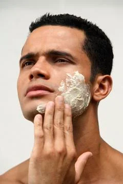 Man applying natural face scrub Stock Photos