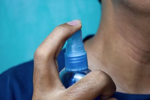 Man applying perfume Stock Photos
