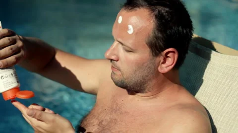 Man applying protection lotion on his face Stock Footage 1097284